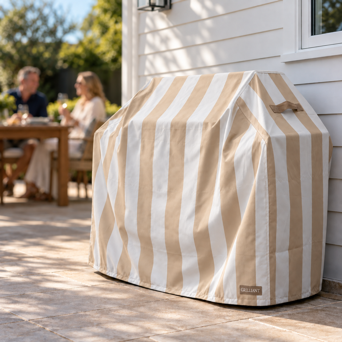 Grilliant striped BBQ cover against a wall in an Australian backyard